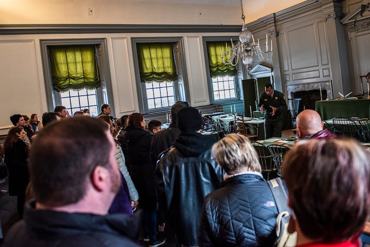 Park ranger Eric Knight introduces the history of Independence Hall to visitors at Independence Hall in Philadelphia.