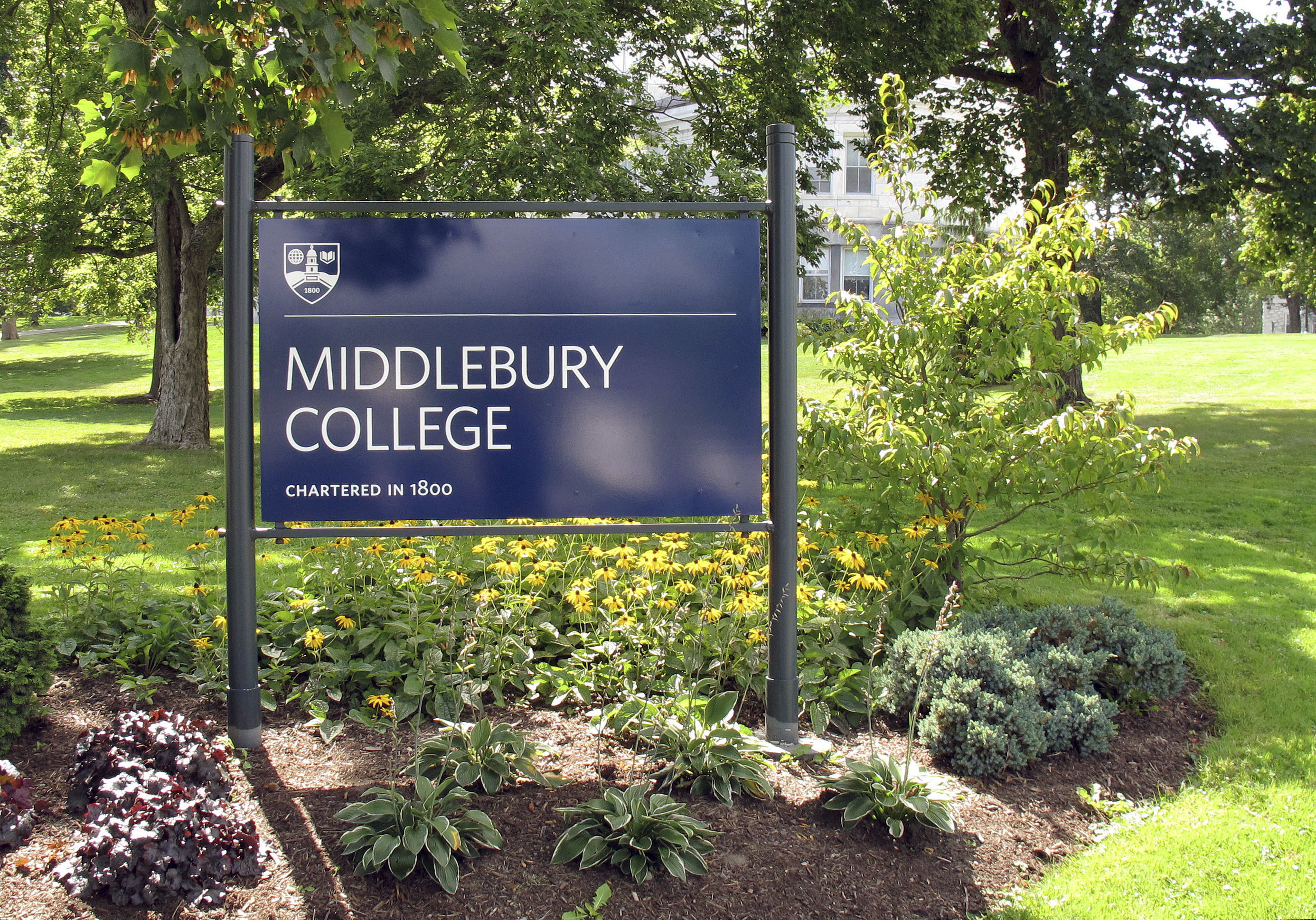 FILE - This Aug. 31, 2017, file photo, shows a sign for Middlebury College on the campus in Middlebury, Vt. A Middlebury College chemistry professor whose written exam question asked students to calculate the lethal dose of a poisonous gas used in Nazi gas chambers during the Holocaust has taken a leave of absence, the school said. (AP Photo/Wilson Ring, File)