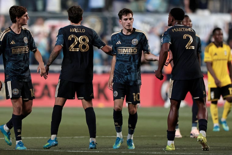 Union forward Milan Iloski high-fives teammates after scoring the Union’s lone goal against the Columbus Crew at Subaru Park in Chester on Saturday.