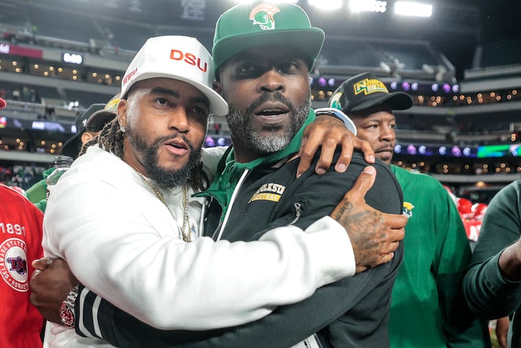 DeSean Jackson (left) and Michael Vick embrace after Jackson's Delaware State team beat Vick's Norfolk State squad, 27-20, on Thursday at Lincoln Financial Field.
