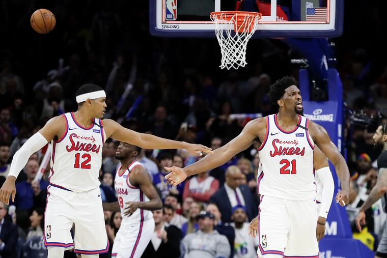 Sixers center Joel Embiid (right) and teammate forward Tobias Harris hope to start their season on Dec. 23 at the Wells Fargo Center.