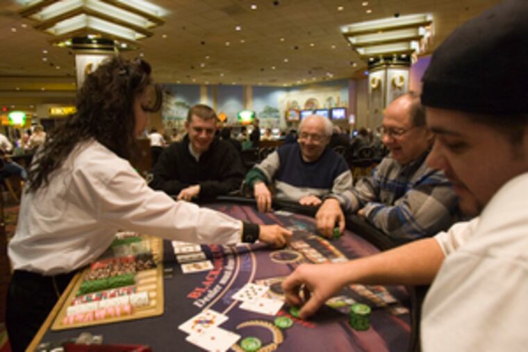 At a Caesars Atlantic City blackjack table in January were dealer Sukie Howard (left) and Igor Wolfson, Francis Cromyak, Joe Bobeck and Robert Pinkiewicz. Revenue fell 15.1 percent.