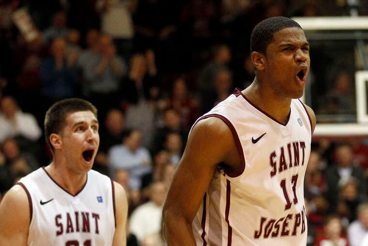 Ron Roberts dunks over Dayton's Alex Gavrilovic (below), then exults with teammate Halil Kanacevic during second half of Hawks' victory.