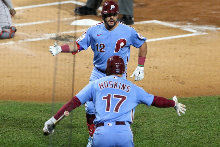 Kyle Schwarber celebrates his first-inning home run with Rhys Hoskins.