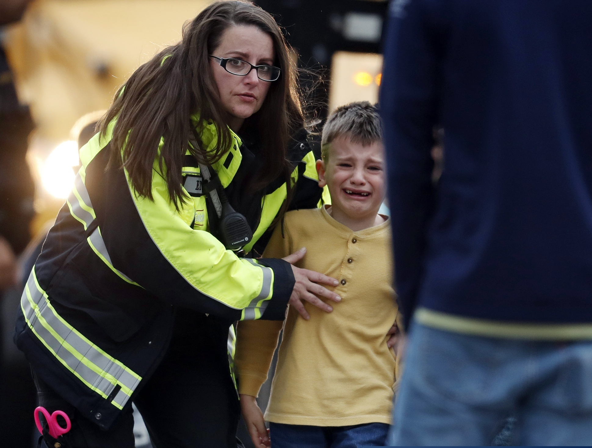 Officials guide students off a bus and into a recreation center where they were reunited with their parents after a shooting at a charter school in Highlands Ranch, Colo., on Tuesday.