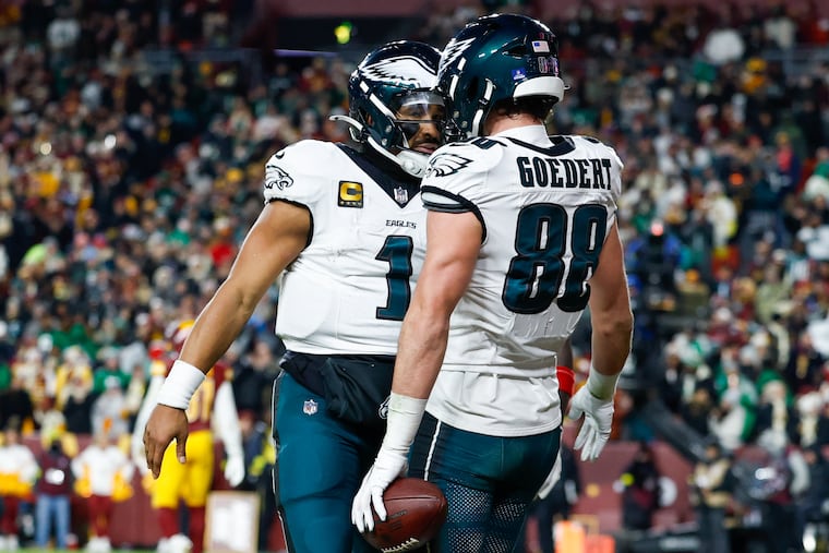 Eagles tight end Dallas Goedert celebrates his third-quarter touchdown with quarterback Jalen Hurts in Saturday's win.
