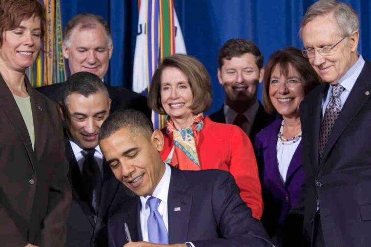 Rep. Barney Frank (left) applauds repeal of "Don't Ask, Don't Tell" legislation, signed by President Obama (above) yesterday.