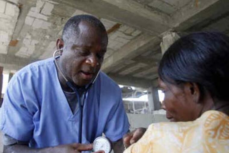 Luc Bouquet, a Haitian American nurse practitioner, works at his Lilavois church and clinic. (David Swanson / Staff Photographer)