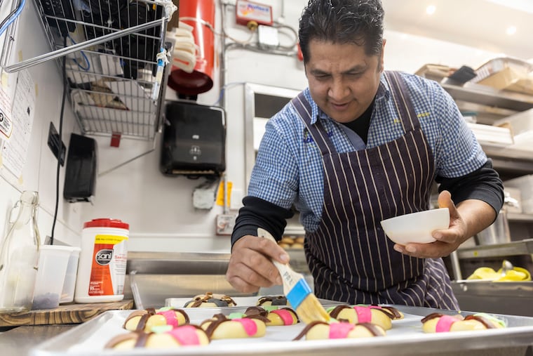 Chef Carlos Aparicio brushes melted butter on his rosca de reyes at El Chingón in Philadelphia on Wednesday. Rosca de reyes is a traditional sweet bread prepared for Three Kings Day on Jan. 6.