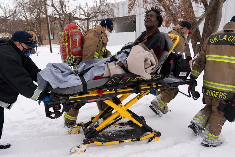 Eugene Rich, suffering from frostbite, is transferred to a hospital in Oklahoma City, Okla., on Tuesday.