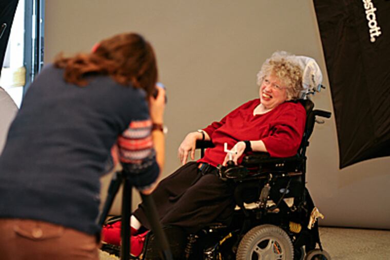 Gina Minter smiles for photographer Lauren Pupillo, taking her portrait at Inglis House in Wynnefield. (Ron Tarver / Staff Photographer)