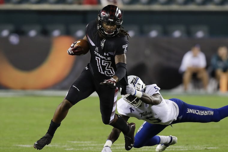 Temple wide receiver Isaiah Wright runs with the football as Tulsa safety McKinley Whitfield grabs Wright's jersey during the second-quarter on Thursday, September 20, 2018 in Philadelphia. YONG KIM / Staff Photographer