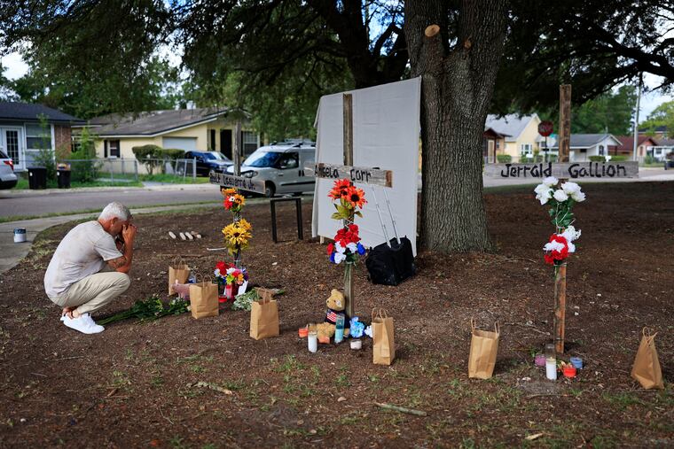 Will Walsh, of Nocatee, Fla., prays in front of three crosses honoring the victims of Saturday's shooting near the site of the attack at a Dollar General store in Jacksonville, Fla., Monday, Aug. 28, 2023.