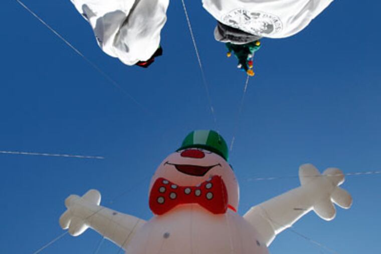 The Snowman balloon moves along the Ben Franklin Parkway near 22nd Street during the 93rd annual Thanksgiving Day parade in Philadelphia on November 22, 2012. ( DAVID MAIALETTI / Staff Photographer )