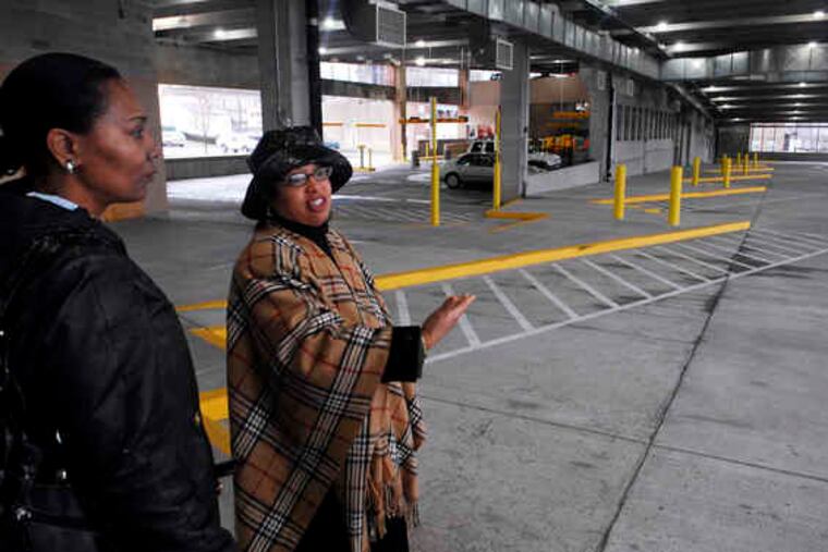 Norristown Councilwoman Linda Christian (left) and Rochelle Culbreath, of SEPTA, look across the bus terminal whose future grew cloudy after a key tenant filed for bankruptcy before moving in.