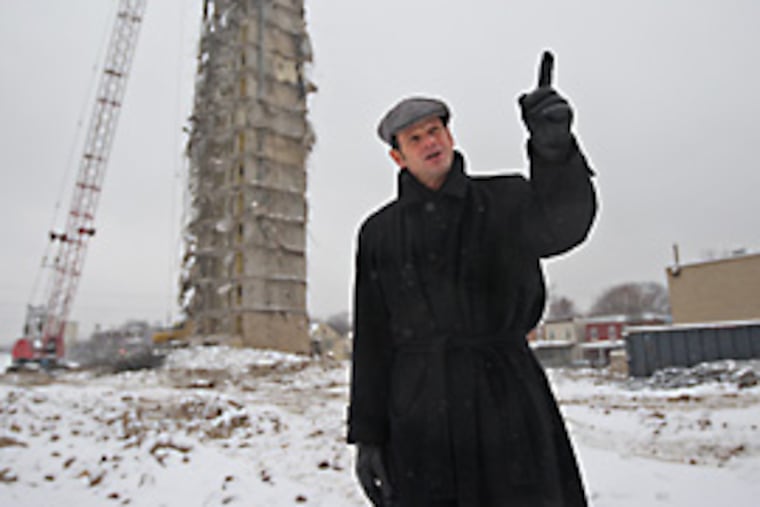 Steven Fischer, executive director of the Chester Public Housing Authority, used to have an office in the building behind him that is being destroyed. (Michael Bryant / Inquirer)