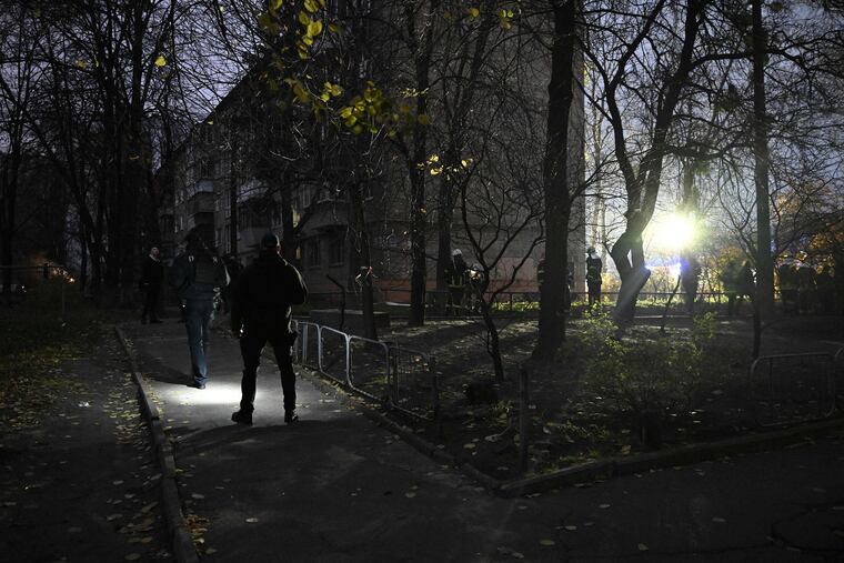 Ukrainian policemen secure a perimeter as firefighters intervene at the scene where a Russian missile fragment fell near a residential building causing fire in the centre of the Ukrainian capital of Kyiv on Tuesday. The Ukrainian presidency said Tuesday that the situation across the country was "critical" after a fresh wave of Russian missiles battered energy facilities, forcing emergency shutdowns and plunging parts of the capital into darkness.