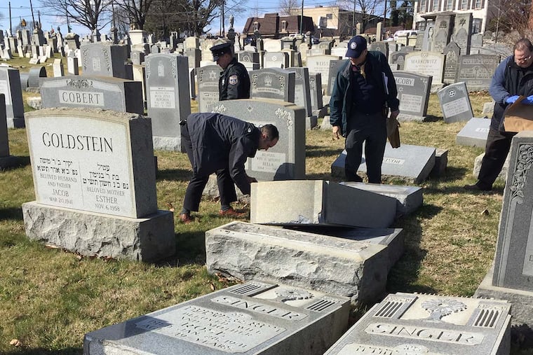 Philadelphia police from the 15th District investigate the report of vandalism at the Mount Carmel cemetery, where hundreds of Philadelphia's early Jewish residents are buried. Vandals reportedly toppled or damaged as many as 100 gravestones, snapping some of them off at the base.