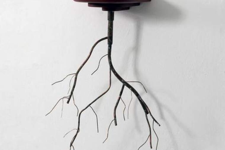 Alejandro Mendoza’s mixed-media sculpture, “Requiem.” His artwork reflects his search for a sense of place.