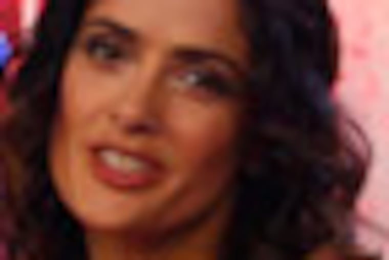 Flanked by Donald Duck,mexican actress Salma Hayek poses for photographers in Disneylands theme park in Marne-la-Vallee, east of Paris, Saturday March 31, 2012. This will mark the 20th year since Disneyland opened in Paris in 1992.(AP Photo/Michel Spingler)