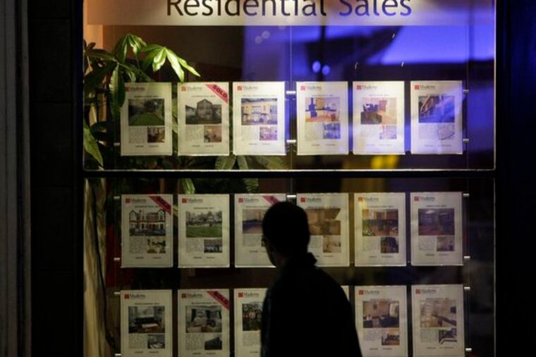 In Balham, South London, a man looks at the details of property for sale on display in the window of a real estate agent. A leading property researcher says house prices in Britain fell by nearly 9 percent in 2008, and are likely to fall further next year as buyers are deterred by the economic slowdown.