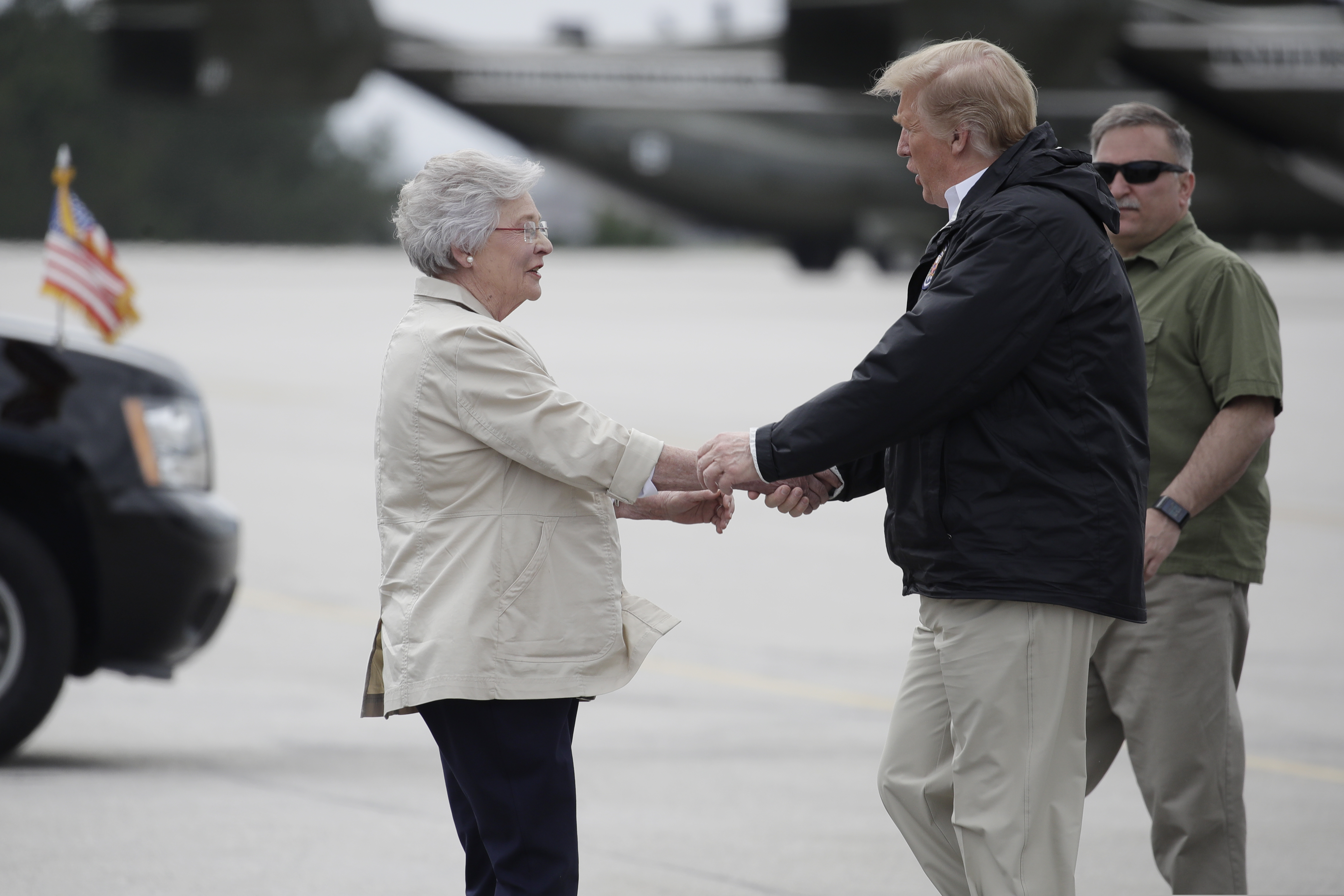 President Donald Trump is greeted by Alabama Gov. Kay Ivey on Trump's arrival, Friday, March 8, 2019, in Auburn, Ala., en route to Lee County, Ala., where tornados killed 23 people.