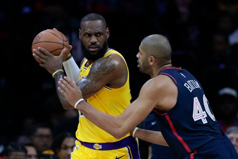 Nicolas Batum guards Lakers forward LeBron James on Nov. 27.