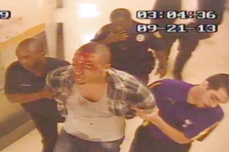 Roscoe Robert Coney is led to a detention cell at Harrah's Atlantic City Casino and Resort following an altercation with security guards on Sept. 21, 2013.