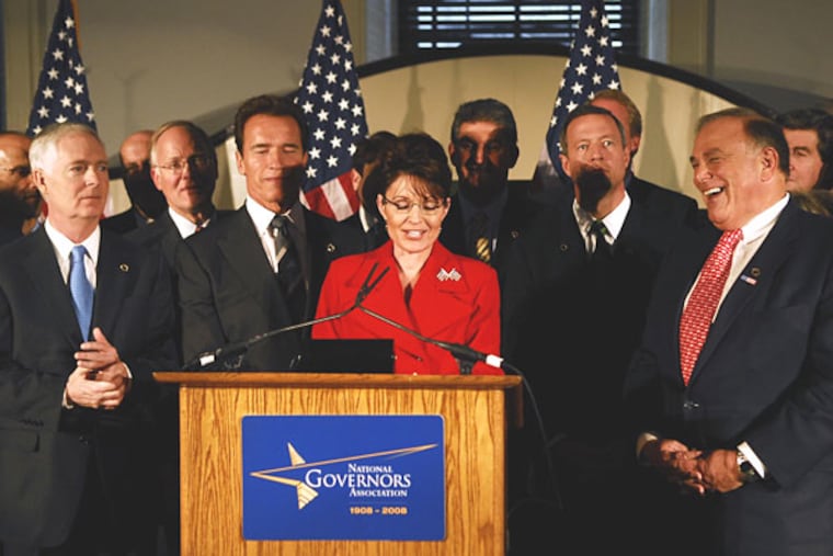 As Gov. Rendell looks on, Alaska Gov. Sarah Palin prepares to answer questions during a news conference held after the NGA conference at Independence Hall.