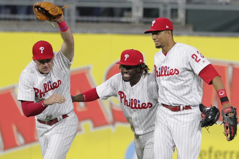 Phillies (from left) Rhys Hoskins, Odubel Herrera and Aaron Altherr celebrating a victory over the Diamondbacks in April.
