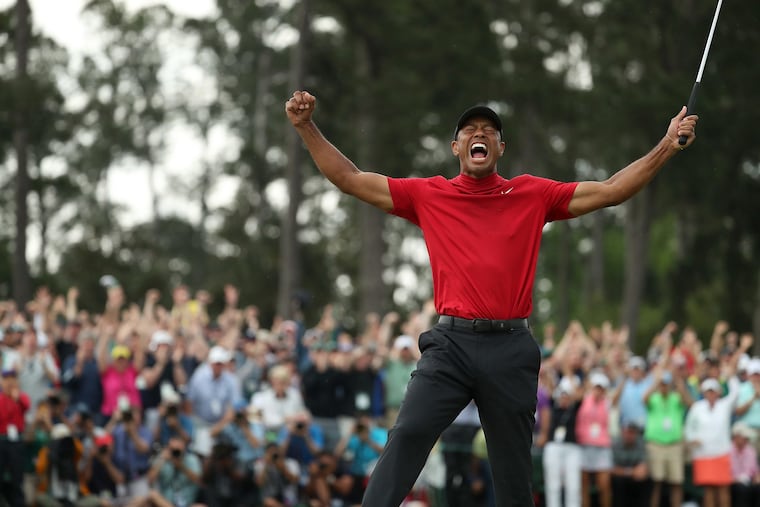 Tiger Woods celebrates his Masters victory at Augusta on Sunday.