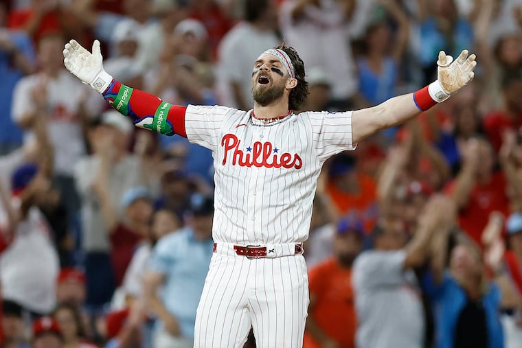 Phillies' Bryce Harper celebrates his fifth inning two-run triple against the Mets that gave him his first-career cycle.