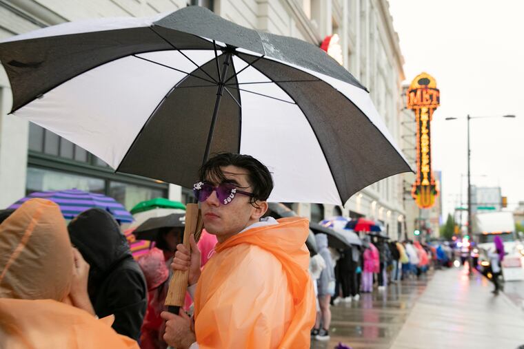Fans wait in the rain and wind as they line up for the Olivia Rodrigo concert in May. More rains were pestering the region Saturday.