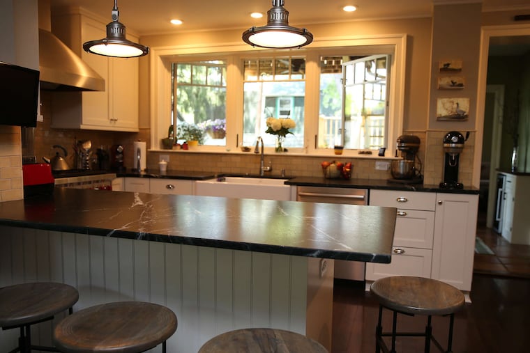Soapstone, as on this kitchen peninsula, "is one of my absolute favorite countertop materials. It’s just gorgeous," says architect Carmel Greer, who hosts the home improvement podcast "On Time, Under Budget, With Love."