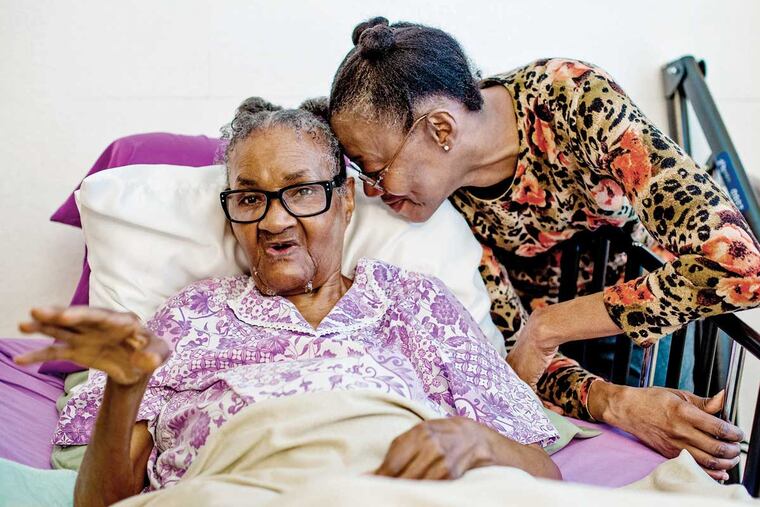 Rea York (R) listens as her mother Dorothy speaks with a reporter in Philadelphia, Pennsylvania, November 24, 2015. York is caring for her 86-year-old mother who is bed bound and has Alzheimers.