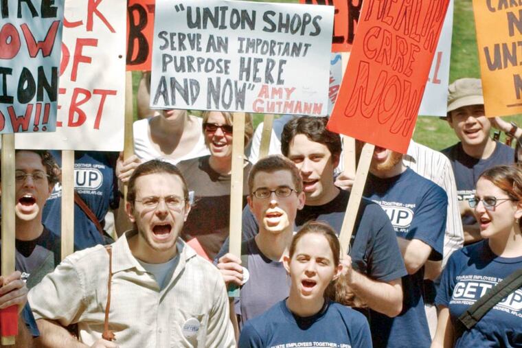 Penn grad student Joe Drury (left) firing up fellow graduate students at a 2005 rally calling for university-related health-care benefits. Their union organizing efforts were stymied by a 2004 decision, but Tuesday’s ruling could allow today’s students to unionize.