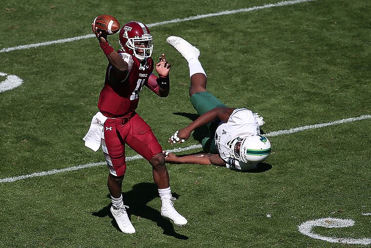 Temple quarterback P.J. Walker throws as Tulane's Royce LaFrance falls.
