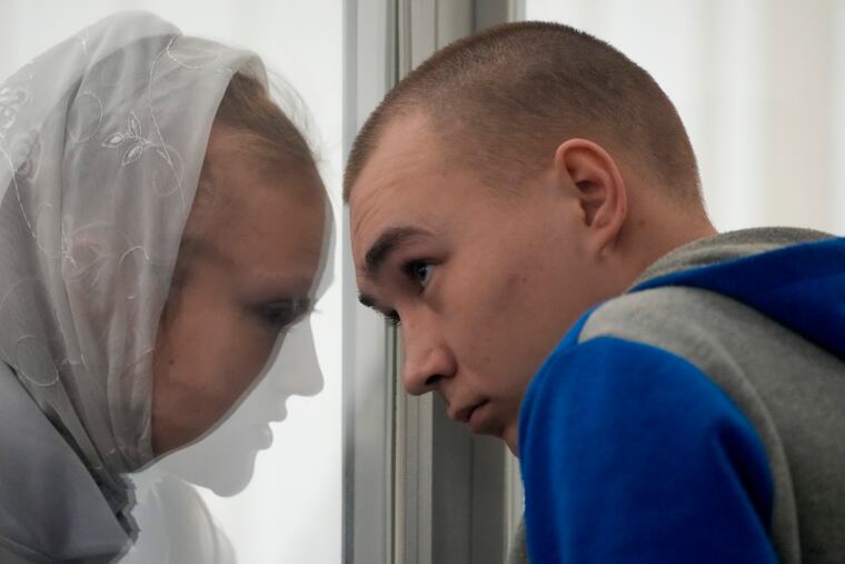 Russian Sgt. Vadim Shishimarin (right) listens to his translator during a court hearing in Kyiv, Ukraine, on Monday.