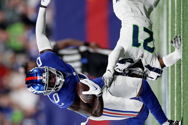 New York Giants wide receiver Parris Campbell (0) avoids a tackle by Seattle Seahawks cornerback Devon Witherspoon (21) during the second quarter of an NFL football game, Monday, Oct. 2, 2023, in East Rutherford, N.J. (AP Photo/Adam Hunger)