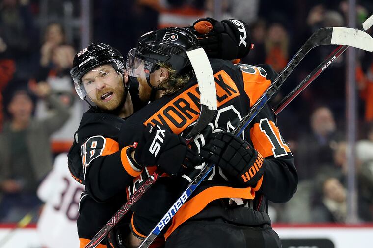 Claude Giroux, left, celebrates a goal last season with Jake Voracek and Sean Couturier.