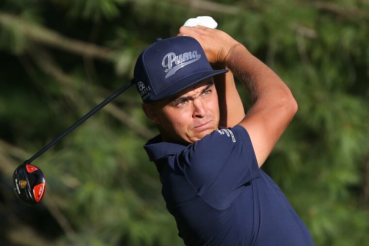 Rickie Fowler watches tee shot on first hole of the the PGA Championship on Thursday.
