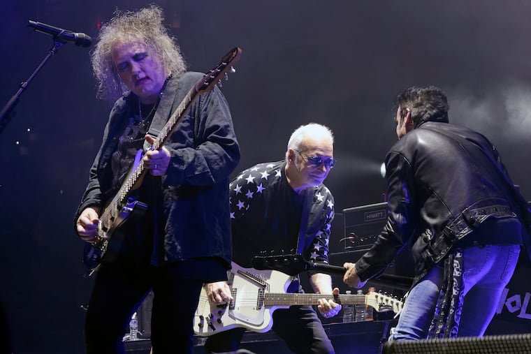 The Cure’s Robert Smith (left), guitarist Reeves Gabrels, and bassist Simon Gallup perform at the Wells Fargo Center in Philadelphia on Saturday, a stop along their 2023 North American tour.