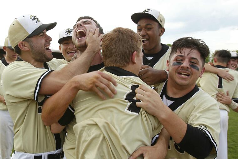 Neumann-Goretti players celebrate their Catholic League championship win over Roman Catholic.