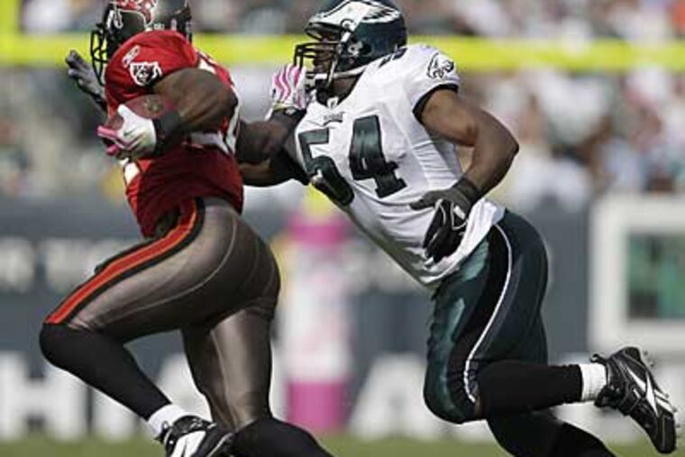 Jeremiah Trotter, right, goes for a tackle on Tampa Bay running back Carnell Williams in his first game back with the Eagles. (David Maialetti / Staff Photographer)