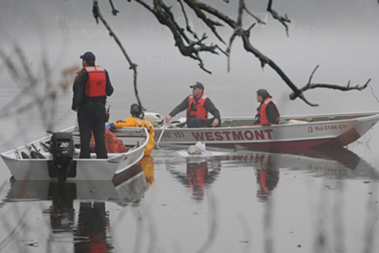 Rescue crews work at the scene of a fatal accident in Collingswood. A Rutgers-Camden student drove into Newton Lake and was found dead on Wednesday morning. (Curt Hudson / For The Inquirer)