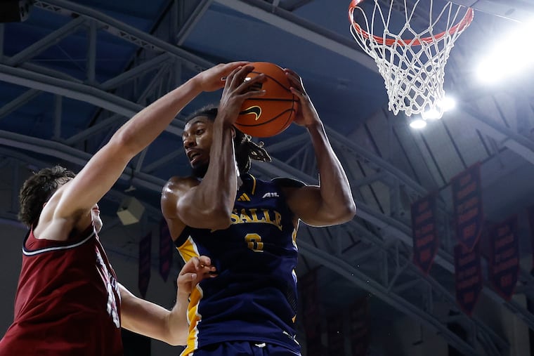 La Salle forward Justin Archer (right) battles with Penn center Dalton Scantlebury at the Palestra earlier this season.