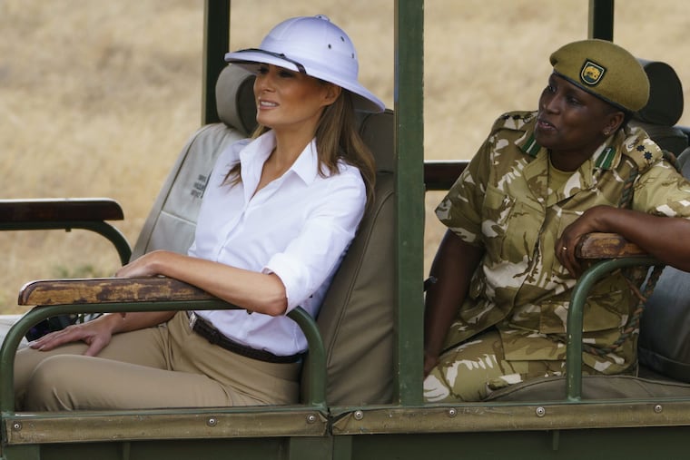First lady Melania Trump looks out over Nairobi National Park in Nairobi, Kenya, Friday, Oct. 5, 2018, during a safari guided by Nelly Palmeris. Melania Trump has fed baby elephants as she visits a national park in Kenya to highlight conservation efforts. The U.S. first lady also went on a quick safari. Mrs. Trump is on her first-ever visit to Africa and her first extended solo international trip as first lady. (AP Photo/Carolyn Kaster)