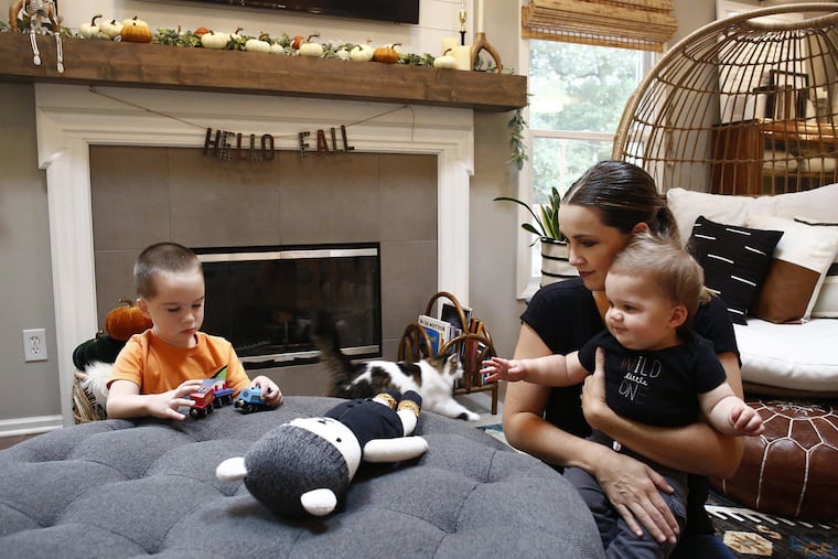 Kelly Pohly left her marketing job in July 2020 to stay home with their three sons after the pandemic increased stress about finding child care, working from home and figuring out the boys' schooling. She is seen with sons, Anderson, 3, and Graham, 10 months old, at their Westerville, Ohio home. (Fred Squillante/Columbus Dispatch/TNS)