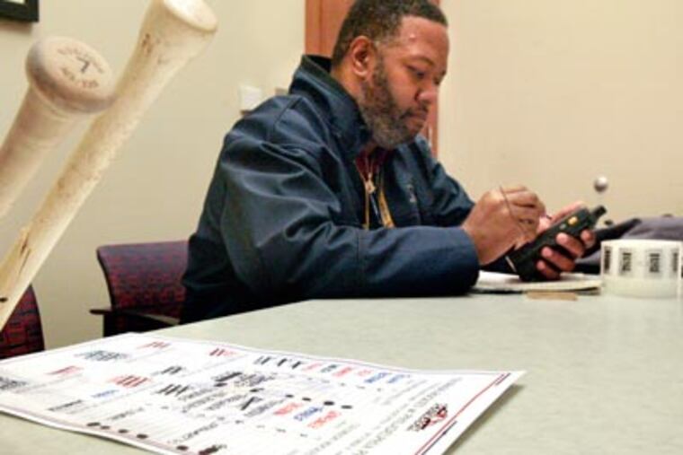 Major League Baseball "authenticator" Bobby Bonds logs broken bats belonging to Jayson Werth and Pedro Feliz and a lineup card after Game 2 of the NLDS. ( Elizabeth Robertson / Staff Photographer )