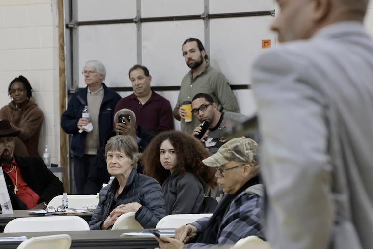 People listen to Camden Mayor Victor Carstarphen (right) during a community meeting for residents affected by the recent junkyard fire, at MJD Fieldhouse Gym on Broadway in Camden on Sunday, Feb. 23, 2025. Heart Of Camden held the meeting as a follow-up to a fire at the European Metal Recycling (EMR) facility in Camden.